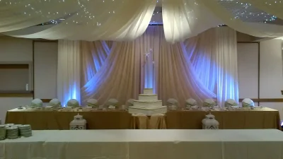 Our largest room called the Diemert room is set up for a wedding with head table beautifully decorated with streaming draperies.