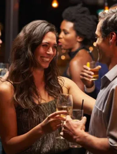 people clinking glasses at a wedding reception